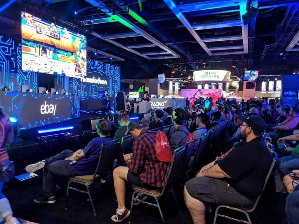 Picture of a large crowd of eSports spectators facing a stage